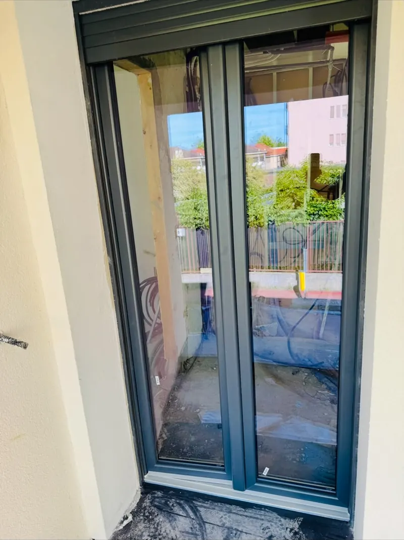 Dark grey French door opening onto a balcony